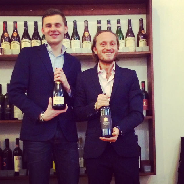 two men holding wine